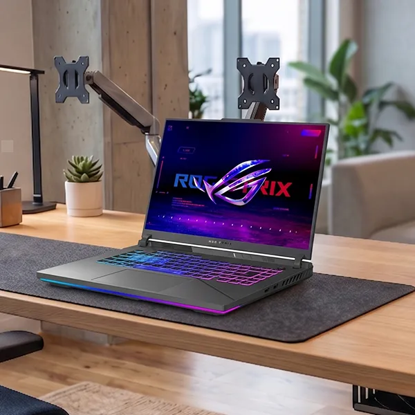 ASUS ROG Strix G16 gaming laptop on a desk in an office setting
